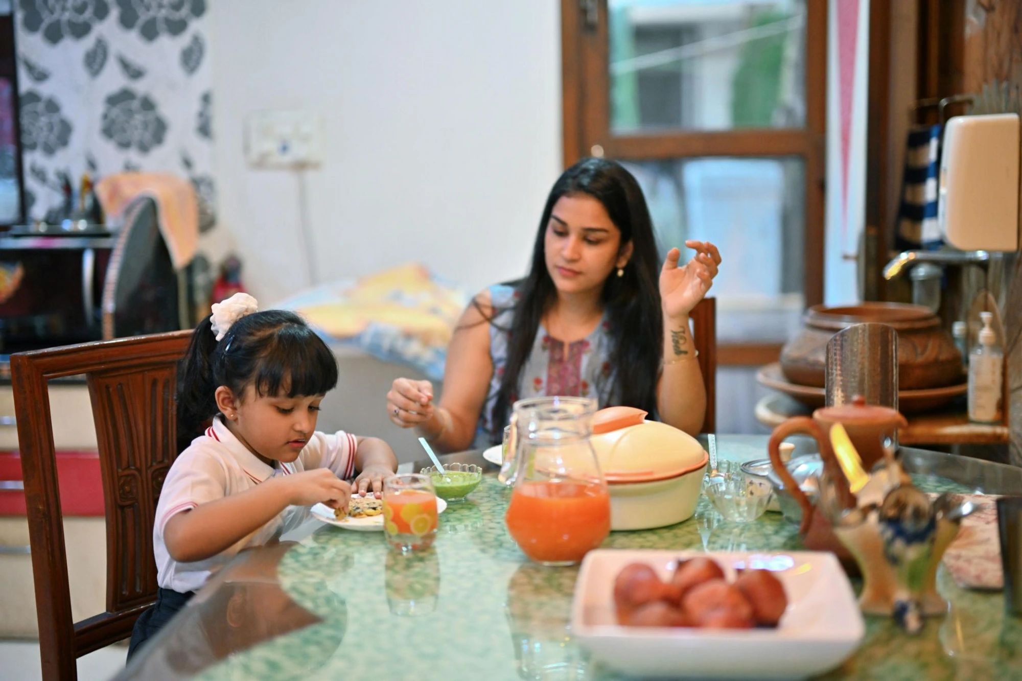 Mother and daughter having breakfast before school